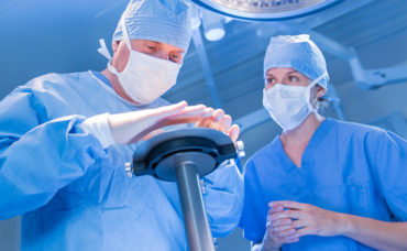 Surgical oncologist and radiation oncologist aligning applicator